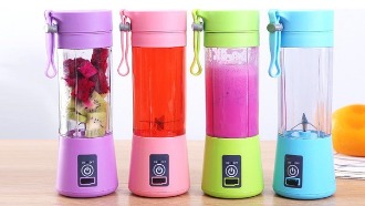 Four blenders, each with a different colored drink inside