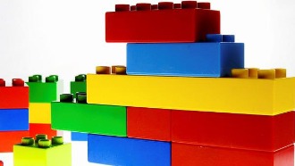 Stack of red, yellow, green, and blue Lego building blocks 